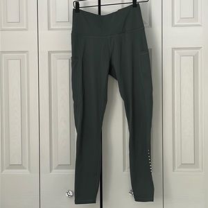 Green leggings with pockets on both sides, worn once in awhile, size M